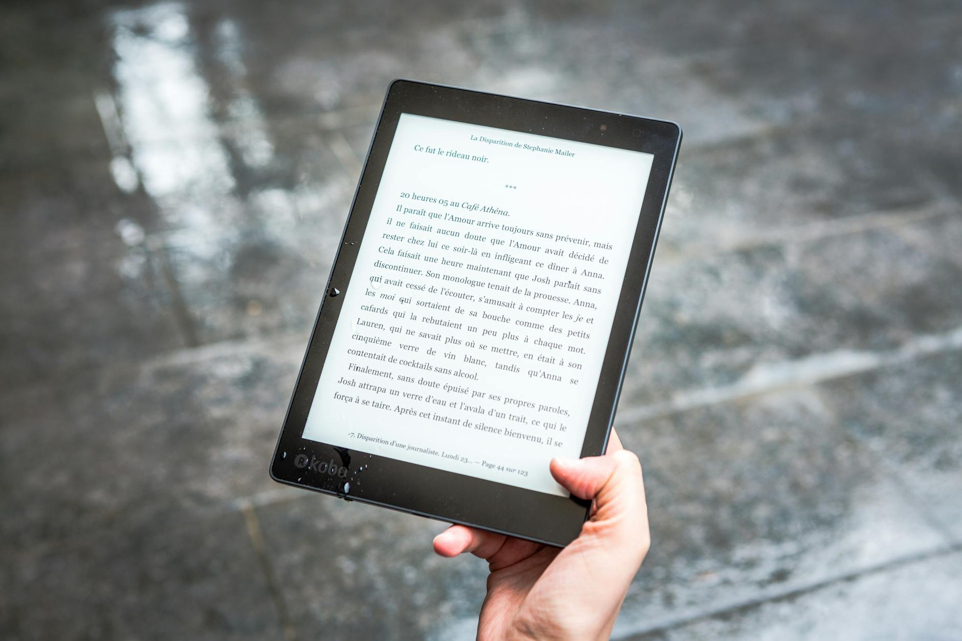 person holding black e book reader