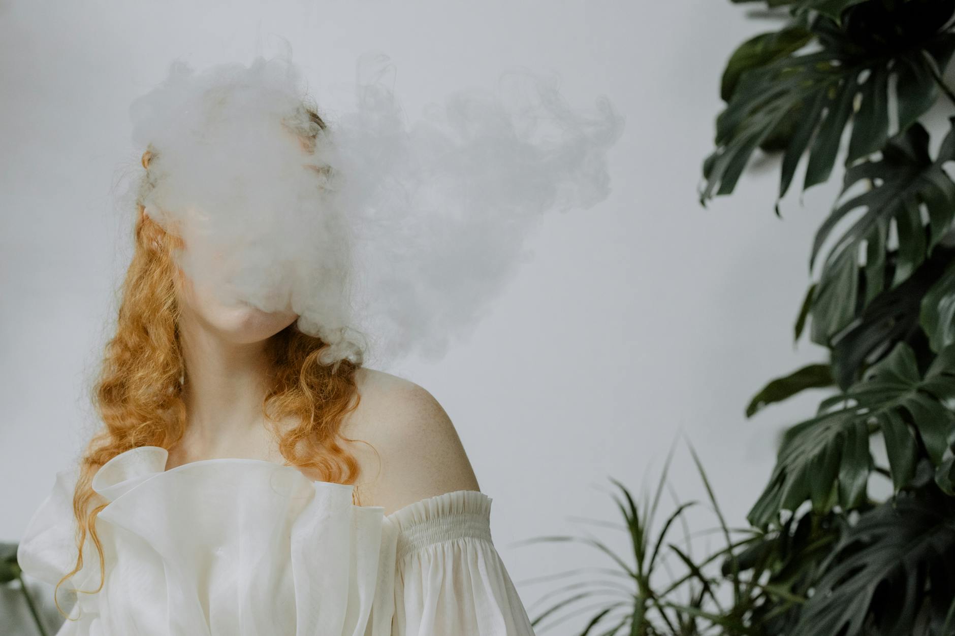 red haired woman behind smoke