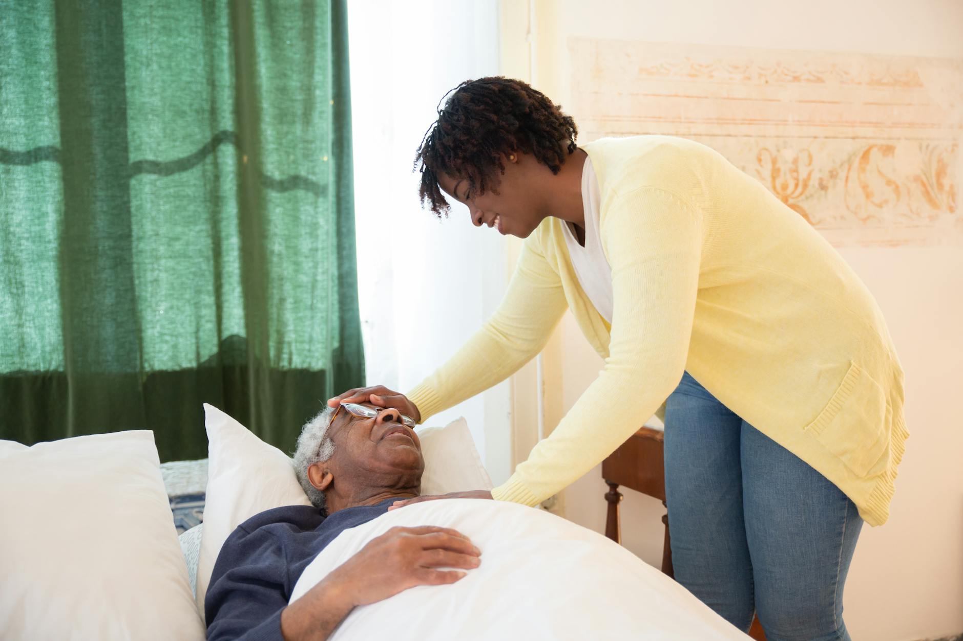woman touching elderly mans head