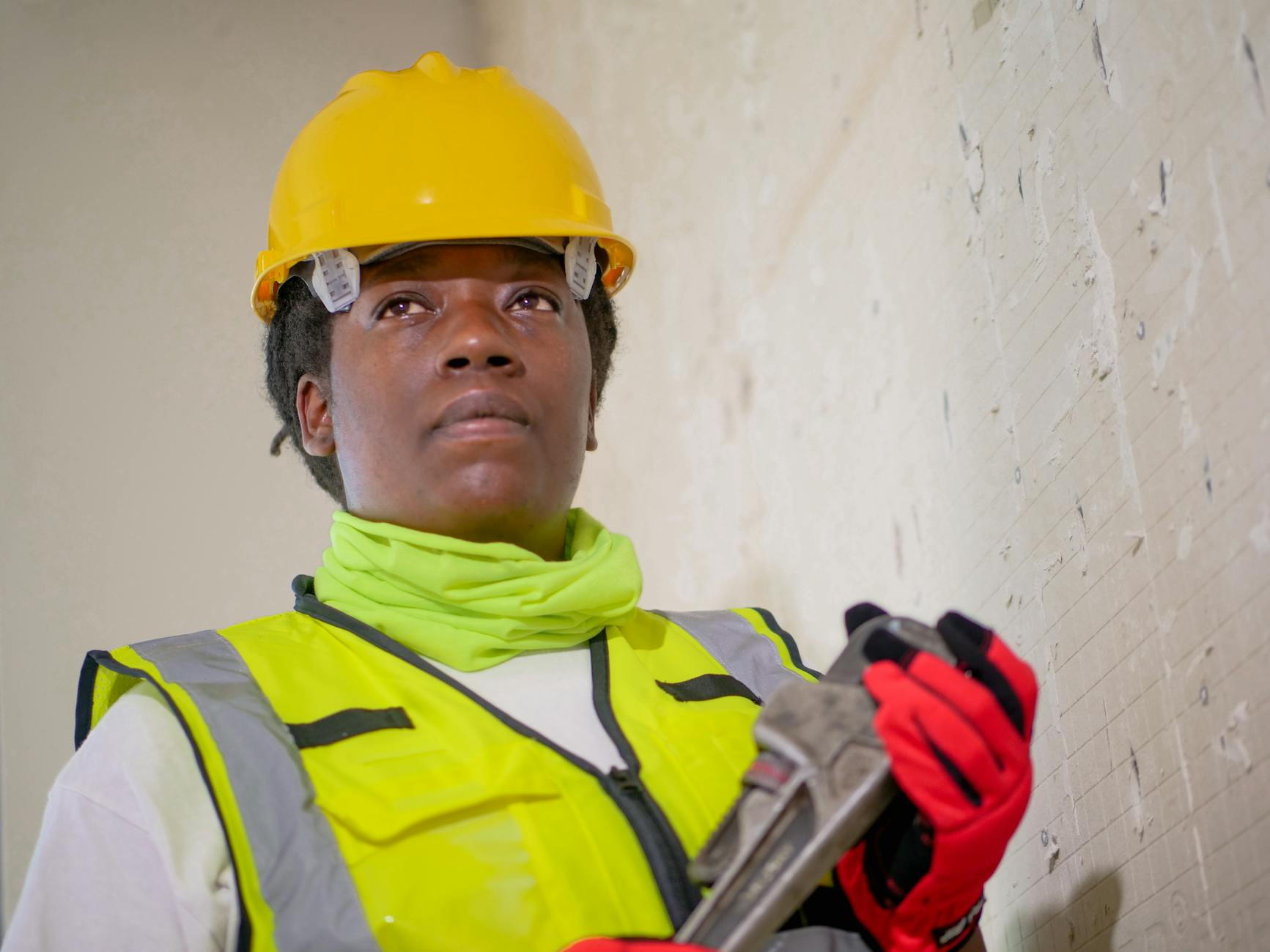 handywoman holding a plumbers wrench