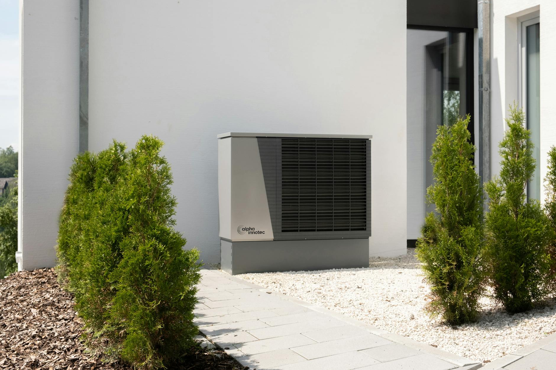 plants near air conditioner and building wall