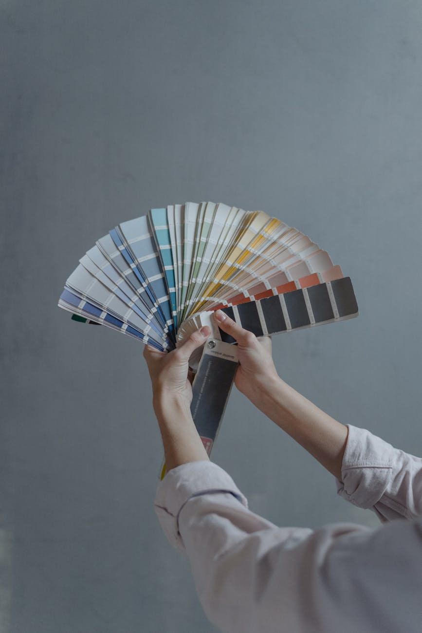 person holding blue white and red hand fan